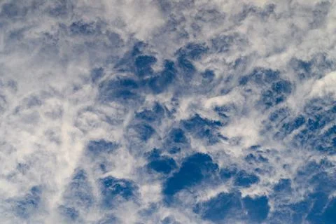 Beautiful Dynamic Cloud Patterns Floating Gracefully Against a Bright Blue Sky A Stock Photos