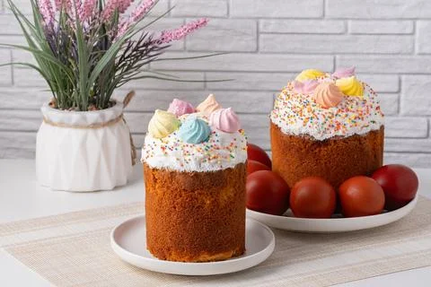Beautiful Easter cake and eggs on light table. Space for text Stock Photos