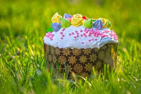 Beautiful Easter cake stands on the grass Stock Photos