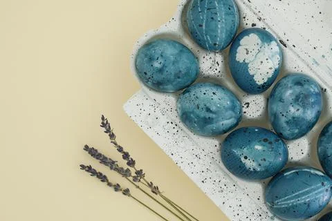Beautiful easter composition of lavender branches and blue easter eggs in a tray Stock Photos
