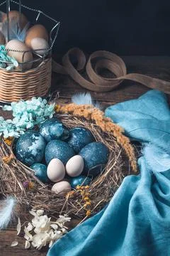 Beautiful Easter composition with painted quail and chicken eggs on a brown Stock Photos