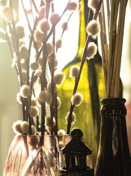 The beautiful easter composition of willow branches, glass and ceramic objects. Stock Photos