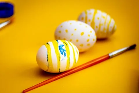 Beautiful easter eggs and a brush. Stock Photos