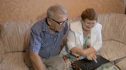 Beautiful elderly couple learns to work on a laptop Stock Footage 67479831