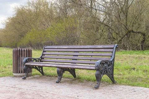 Beautiful empty bench in the spring park Stock Photos
