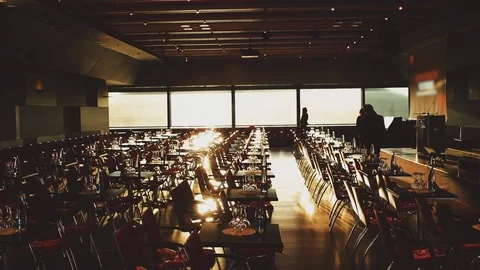 Beautiful empty event, conference hall, gold sunrise light, silhouette people. Stock Footage 114715918
