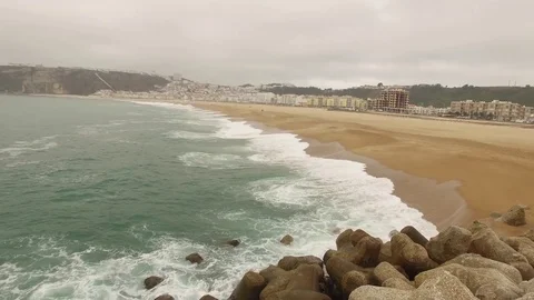 Beautiful empty ocean sandy beach in Nazar , Portugal. Aerial view Stock Footage 80900024