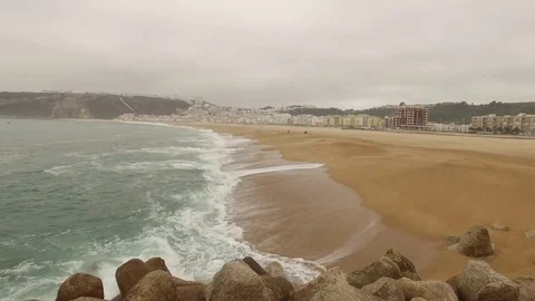 Beautiful empty ocean sandy beach in Nazar , Portugal. Aerial view Stock Footage 80900042