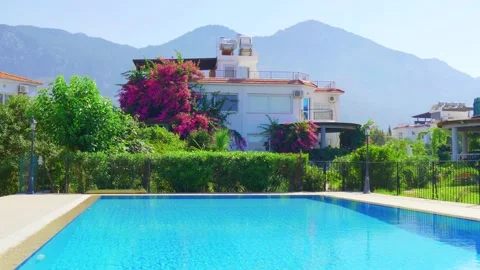 Beautiful empty pool with blue turquoise water and a private house Stock Footage 130722207