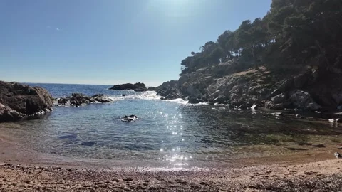 Beautiful empty sand beach with mountain, trees and calm see on sunny day, 4K Stock Footage 271130794