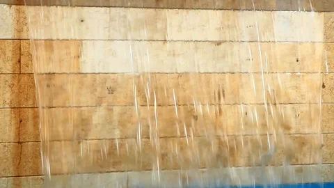 A beautiful even stream flows down a waterfall from clear water down Stock Footage 116050556