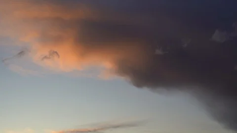 Beautiful evening blue sky at sunset with flaming bright light clouds. A warm su Stock Footage 128650398