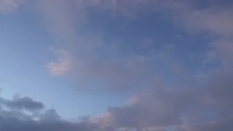Beautiful evening blue sky at sunset with flaming bright light clouds illuminate Stock Footage 142077838