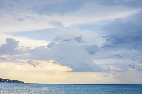 A beautiful evening sky with clouds after the rain, viewed from a pebble be.. Stock Photos