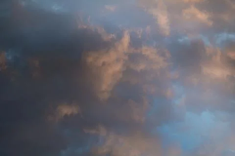 Beautiful evening sky with multi-colored bright clouds. Rain clouds at sunset Stock Photos