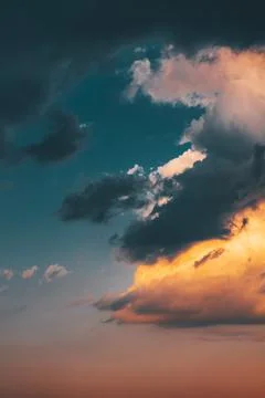 Beautiful evening sky with multi-colored bright clouds. Rain clouds at sunset Stock Photos