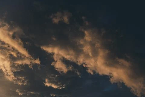 Beautiful evening sky with multi-colored bright clouds. Rain clouds at sunset Stock Photos