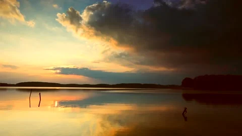 Beautiful evening sky reflected in waters of lake. Spectacular landscape. Stock Footage 155409987