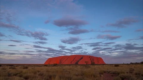 Beautiful evening sunset time lapse video of Uluru in Australia 8K Stock Footage 130228249