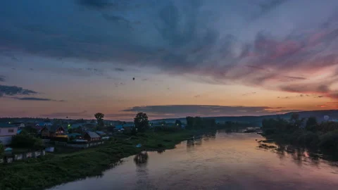 Beautiful evening time lapse by the river with floating air balloon Stock Footage 91713165