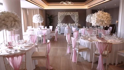 Beautiful event space with floral decorations and table settings for a Видео 335262953