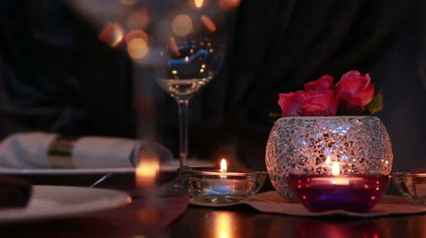 Beautiful expensive table serving for a romantic dinner with candles and roses Stock Footage 48615758
