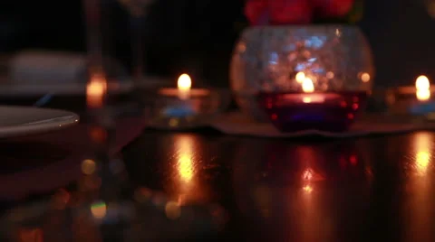 Beautiful expensive table serving for a romantic dinner with candles and red  Stock Footage 48615940