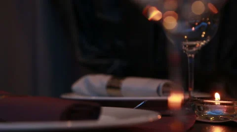 Beautiful expensive table serving for a romantic dinner with candles and red  Stock Footage 48616150