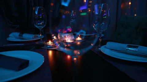 Beautiful expensive table serving for a romantic dinner with candles and red  Stock Footage 48617692