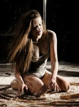 Beautiful expressive dencer dancing at studio with flour or smoke 스톡 사진