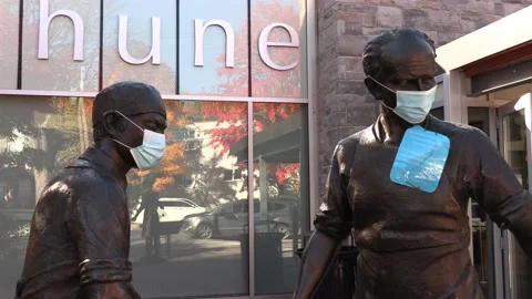 Beautiful fall day with statues wearing masks in the COVID 19 pandemic Stock Footage 140960211