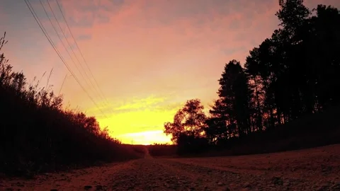 Beautiful Fall Sunset Down a Dirt Road Ambient Nature Relaxation 4K Stock Footage 325008439