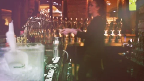 Beautiful female bartender in cool bar vintage film Stock Footage