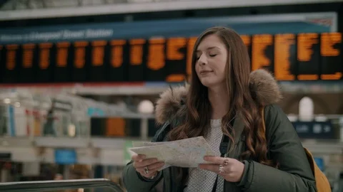 Beautiful female checking map at the station Video stock 114888137