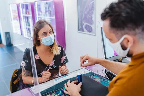 Beautiful female client in a store during pandemic Stock Photos