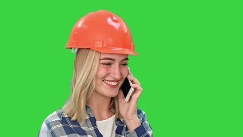 Beautiful female engineer in hardhat calling via cellphone on a Green Screen Stock Footage 73872321