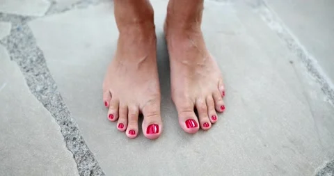 Beautiful female feet with red nails on ... | Stock Video | Pond5