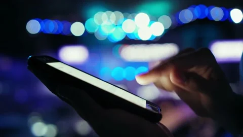 Beautiful female hand writes a message using a smartphone. On the background of Stock Footage 134138334