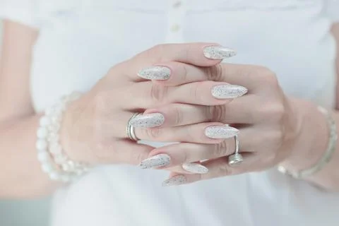 Beautiful female hands with long nails light white manicure Stockfoto's