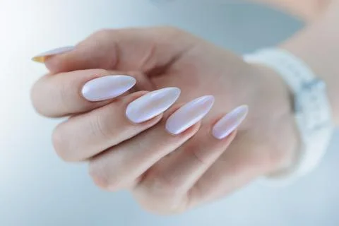 Beautiful female hands with long nails light white manicure Stock Photos