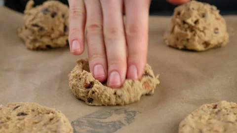Beautiful female hands press the cookie dough on the baking sheet. Woman making Stock Footage 147047892