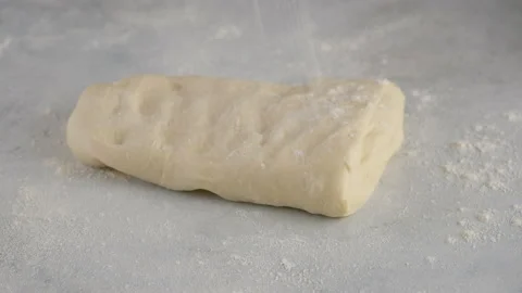 Beautiful female hands in a professional kitchen roll out dough for making bread Stock Footage 145488653