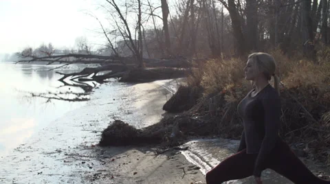 Beautiful female model does yoga by river Stock Footage 33666085