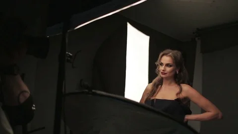 Beautiful female model posing at studio in the light flashes Stock Footage 73778027