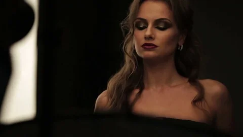 Beautiful female model posing at studio in the light flashes Stock Footage 73778996