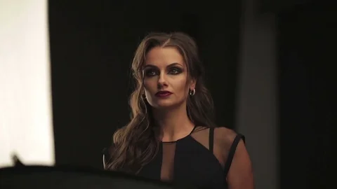 Beautiful female model posing at studio in the light flashes Stock Footage 73779482