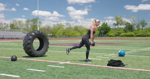Beautiful Female Physical Trainer Exercising Working Out Full Body Weights Stock Footage 154384537