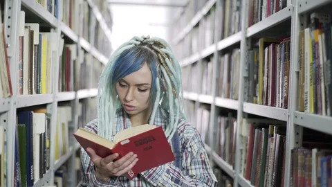 Beautiful female student reading book 스톡 동영상 106941330