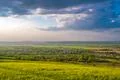 The beautiful field on the background of cloud. Wide angle Photo