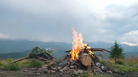 A beautiful fire burns on the background of beautiful mountain nature. Campfire Stock Footage 271598992